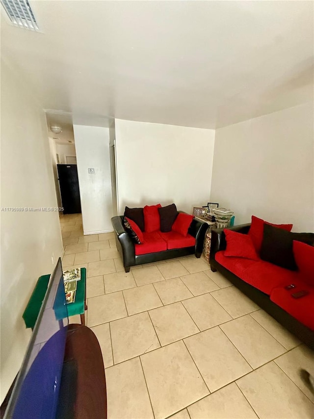 living area with visible vents and light tile patterned flooring