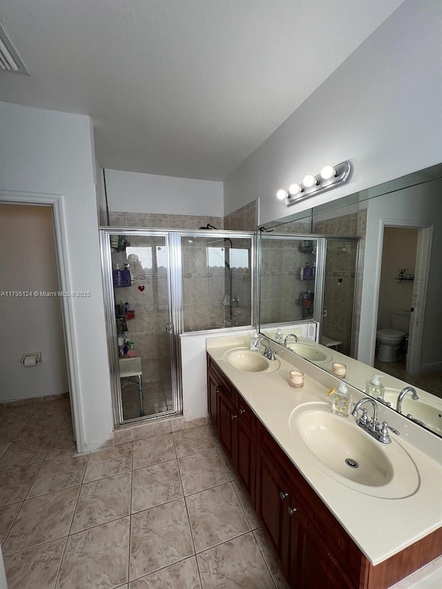 full bath with a sink and a shower stall