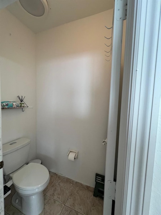 bathroom with tile patterned flooring and toilet
