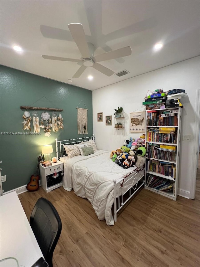 bedroom with ceiling fan, recessed lighting, wood finished floors, and visible vents