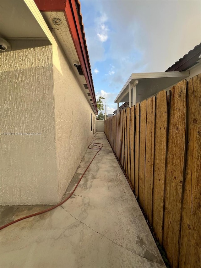view of property exterior featuring fence and stucco siding