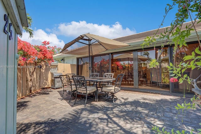 view of patio / terrace with outdoor dining area, fence, and grilling area