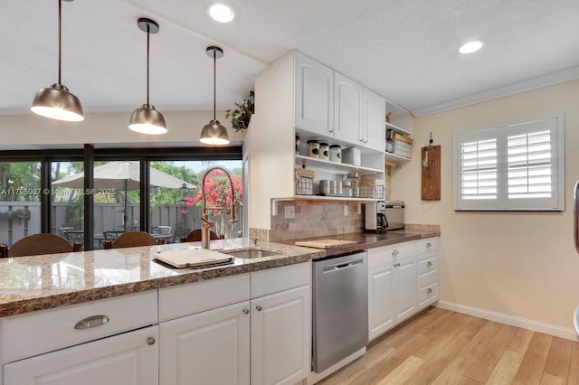 kitchen with stainless steel dishwasher, light wood-style floors, open shelves, baseboards, and backsplash