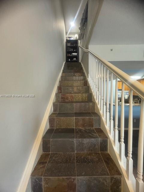 stairs with stone tile flooring
