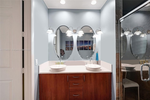 bathroom with a stall shower, double vanity, and recessed lighting