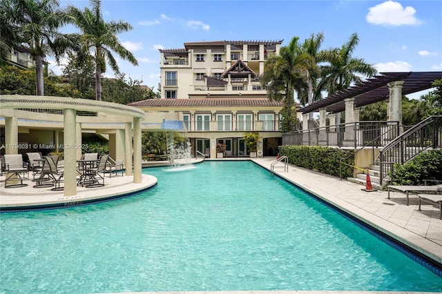 community pool with a pergola, a patio area, and stairs