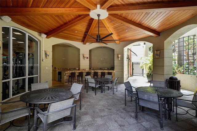view of patio featuring outdoor dining area and a ceiling fan