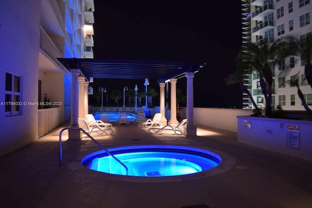 1200 Brickell Bay Dr Unit 2807, Miami, FL 33131 - pool at twilight with a swimming pool, a pergola, a hot tub, and a patio area