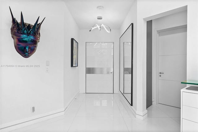 3710 NE 208th Ter, Aventura, FL 33180 - corridor with baseboards, light tile patterned floors, and a chandelier