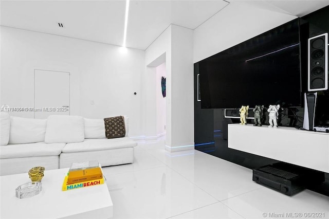 tiled living area featuring baseboards