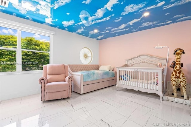 bedroom featuring a nursery area, baseboards, and visible vents