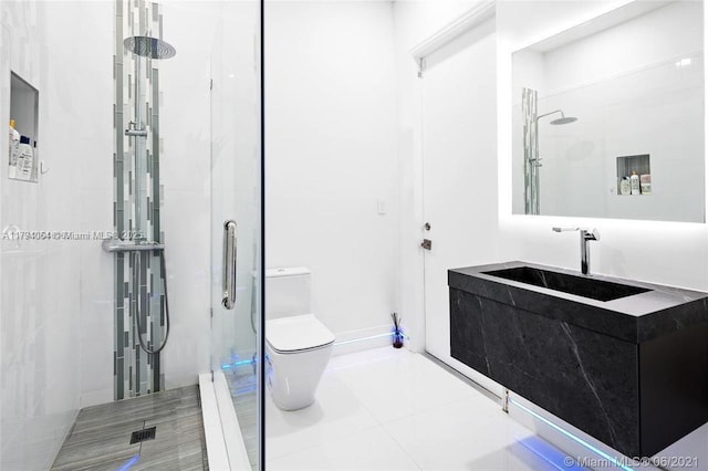 bathroom featuring vanity, tile patterned flooring, a stall shower, and toilet