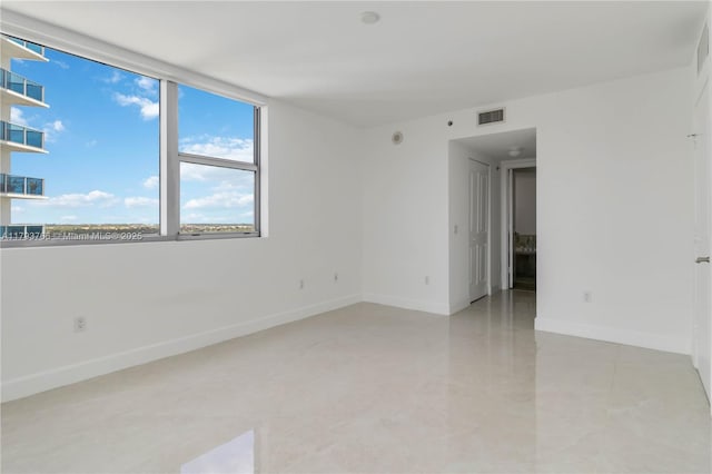 unfurnished room featuring light tile patterned floors, baseboards, and visible vents