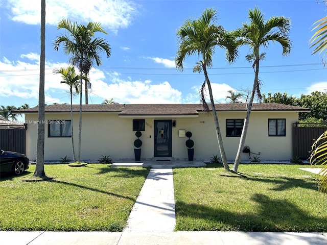 single story home featuring fence, stucco siding, and a front yard