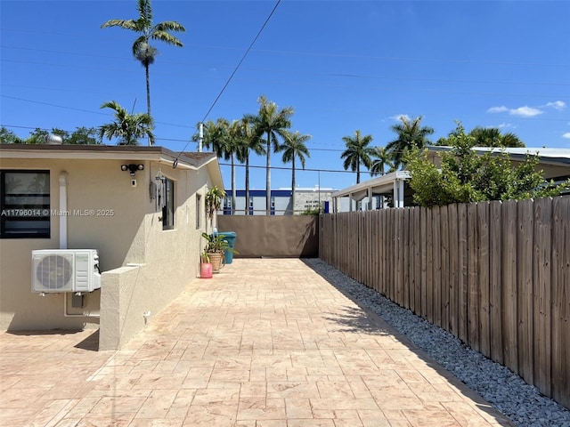 view of patio with fence and ac unit