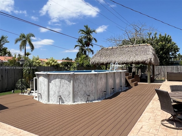 deck featuring a fenced in pool, a gazebo, and a fenced backyard