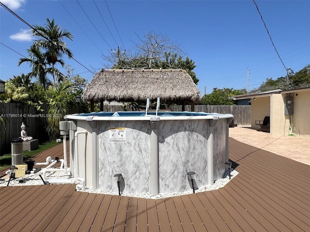 deck with a gazebo, a fenced in pool, and a fenced backyard