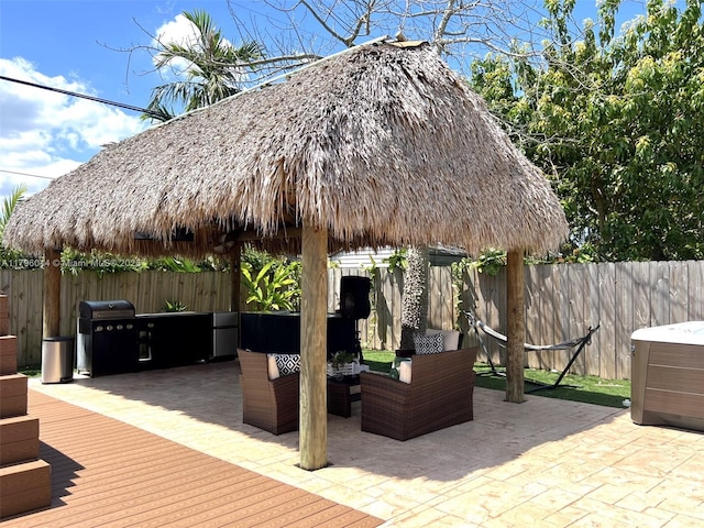 view of patio featuring a gazebo, a fenced backyard, an outdoor living space, and a deck