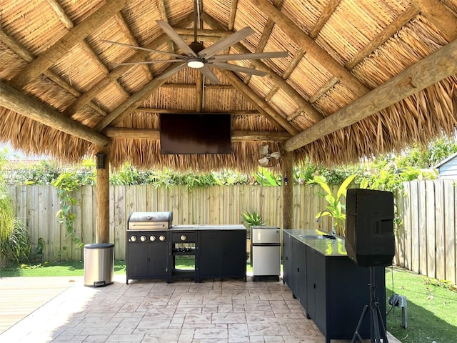 view of patio with a gazebo, a ceiling fan, a sink, and area for grilling