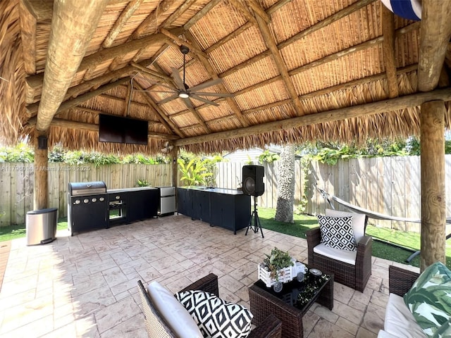 view of patio with a fenced backyard, a ceiling fan, an outdoor hangout area, and a gazebo