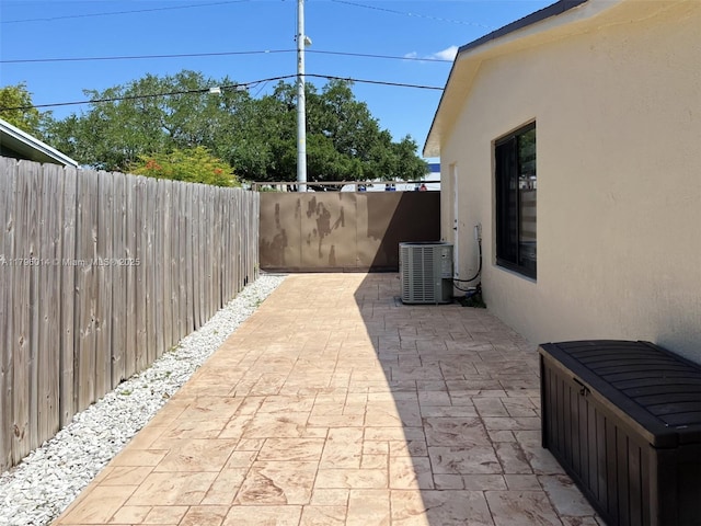 view of patio featuring fence and central AC unit