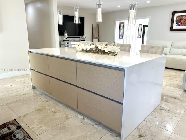 kitchen featuring marble finish floor, open floor plan, a large island, modern cabinets, and light countertops