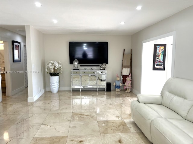living area featuring baseboards, recessed lighting, and marble finish floor