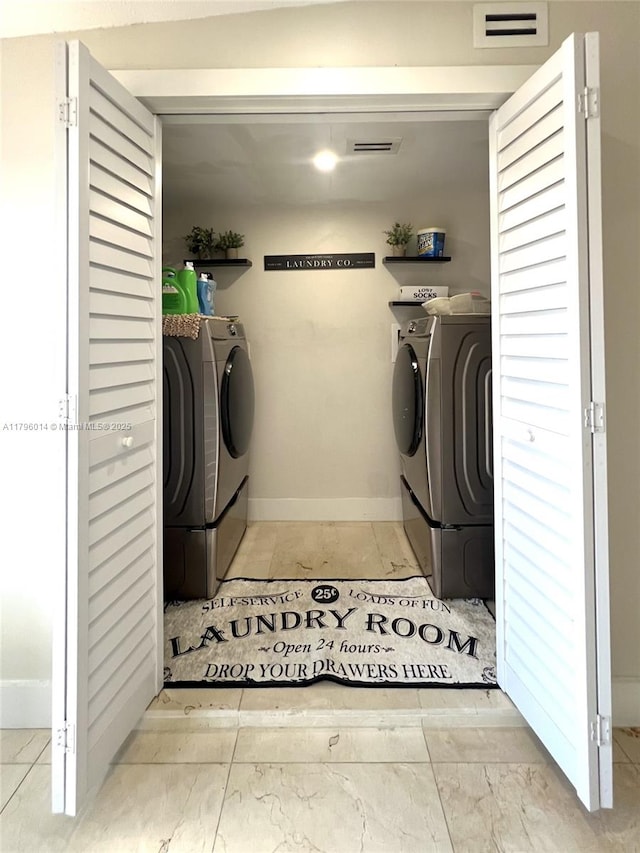 laundry area featuring laundry area, washer and clothes dryer, baseboards, and visible vents