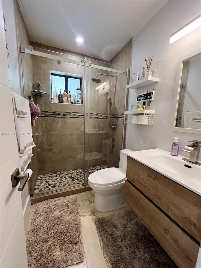 bathroom with vanity, a stall shower, toilet, and marble finish floor