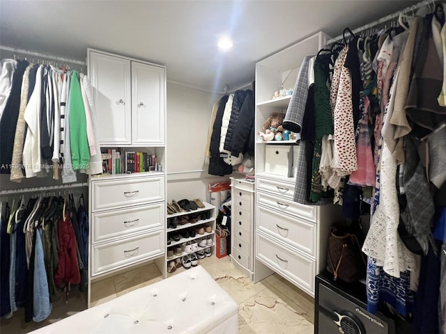 spacious closet with marble finish floor