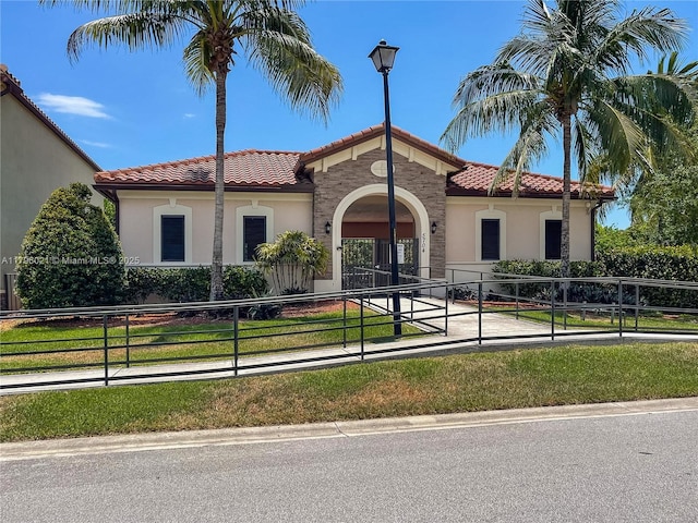 4723 NW 59th St, Tamarac, FL 33319 - mediterranean / spanish-style house featuring a fenced front yard, a tile roof, and stucco siding