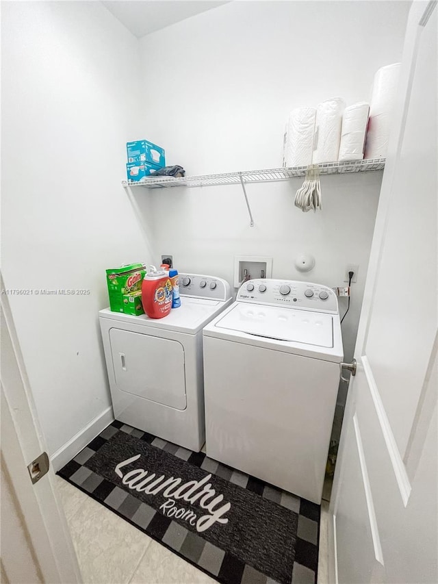 clothes washing area with tile patterned floors, laundry area, and washing machine and dryer