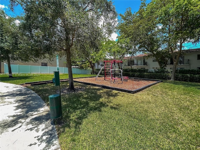 community playground with a lawn and fence