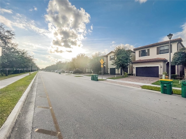 view of road with traffic signs, sidewalks, and curbs