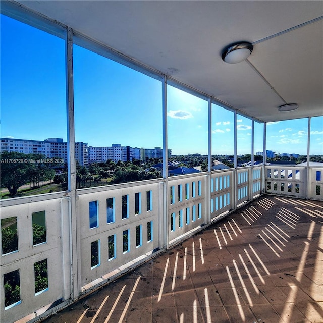 unfurnished sunroom featuring a view of city