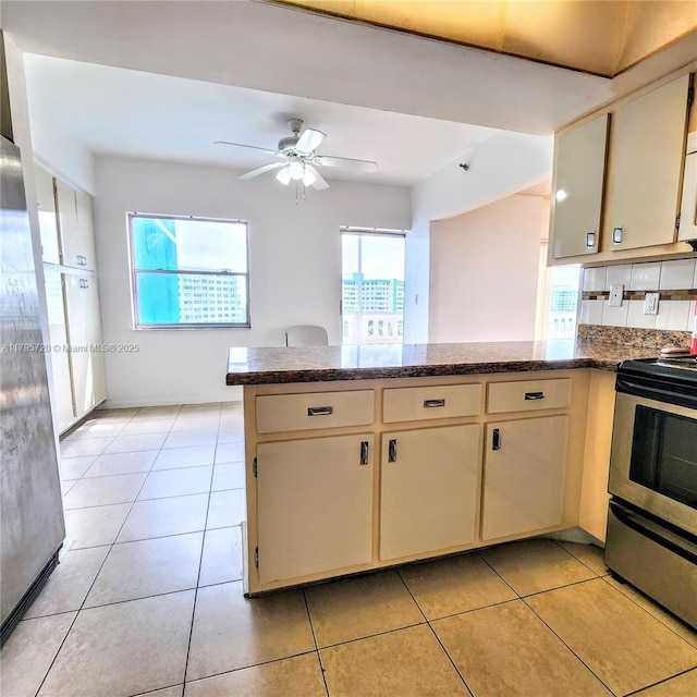 4001 Hillcrest Dr Unit 602-4, Hollywood, FL 33021 - kitchen with stainless steel appliances, a peninsula, cream cabinets, and a ceiling fan