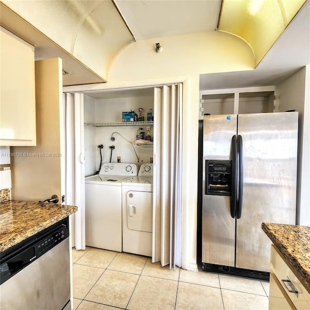 laundry room with laundry area, separate washer and dryer, and light tile patterned flooring