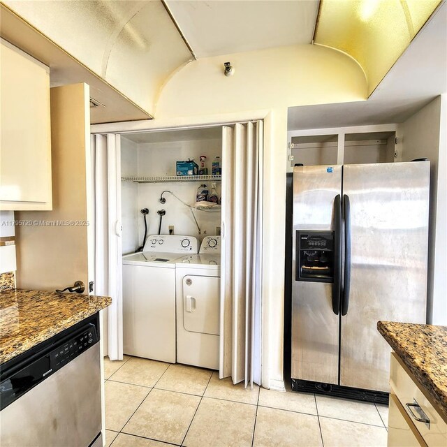 4001 Hillcrest Dr Unit 602-4, Hollywood, FL 33021 - kitchen featuring appliances with stainless steel finishes, light tile patterned floors, washing machine and clothes dryer, and stone counters