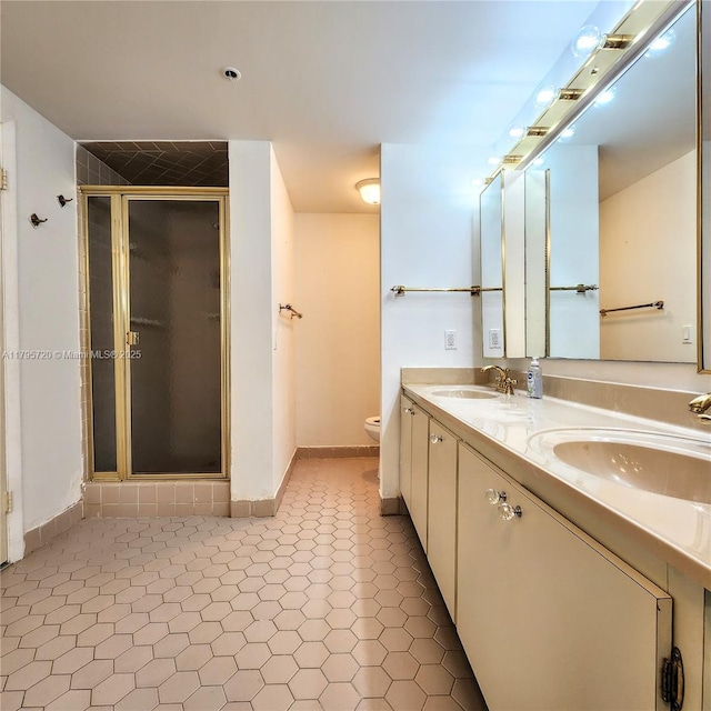 bathroom featuring toilet, a sink, and a stall shower