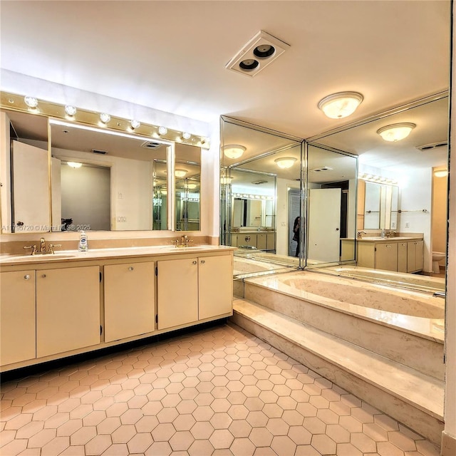 full bathroom featuring a sink, tile patterned flooring, and double vanity