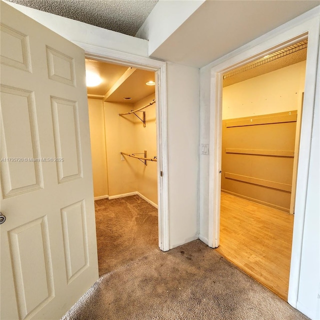 hall featuring carpet floors and baseboards