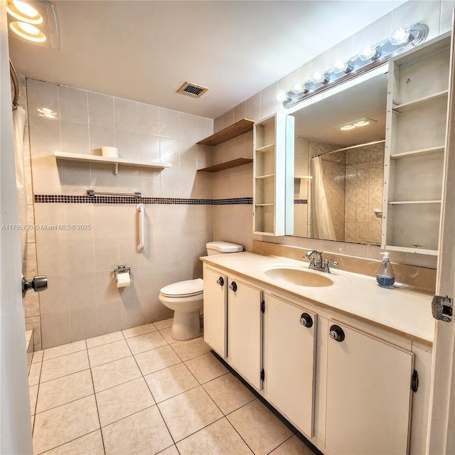 full bath featuring visible vents, tile walls, tile patterned flooring, vanity, and toilet