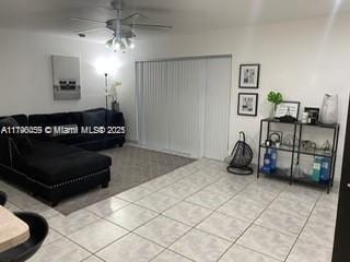 tiled living room featuring a ceiling fan
