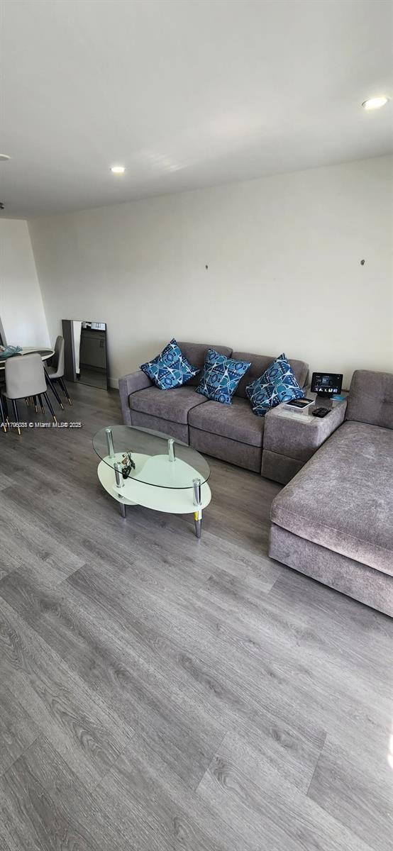 living room with recessed lighting and wood finished floors