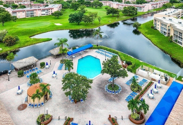 drone / aerial view with view of golf course and a water view