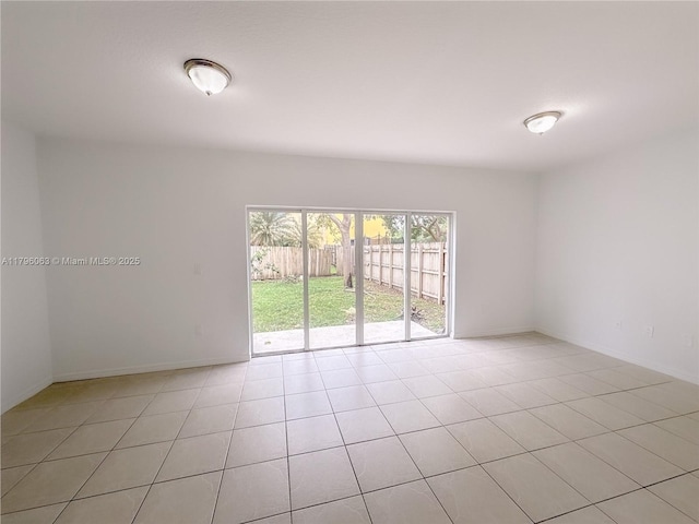 unfurnished room featuring baseboards and light tile patterned floors
