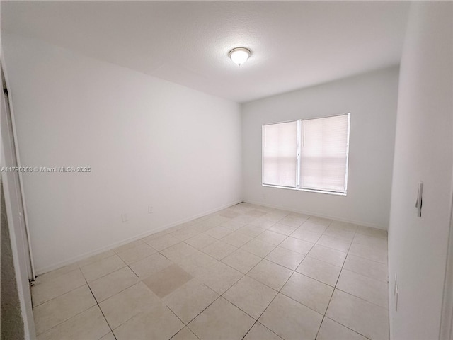 unfurnished room featuring light tile patterned flooring