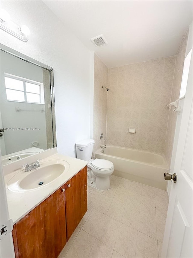 bathroom featuring visible vents, vanity, tile patterned floors, toilet, and bathing tub / shower combination