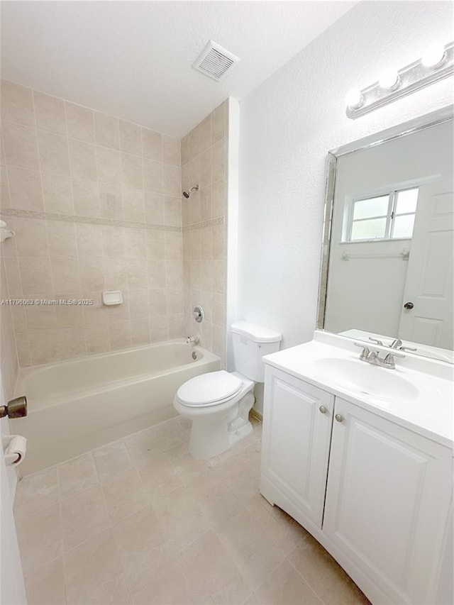 bathroom featuring vanity, toilet, visible vents, and bathtub / shower combination