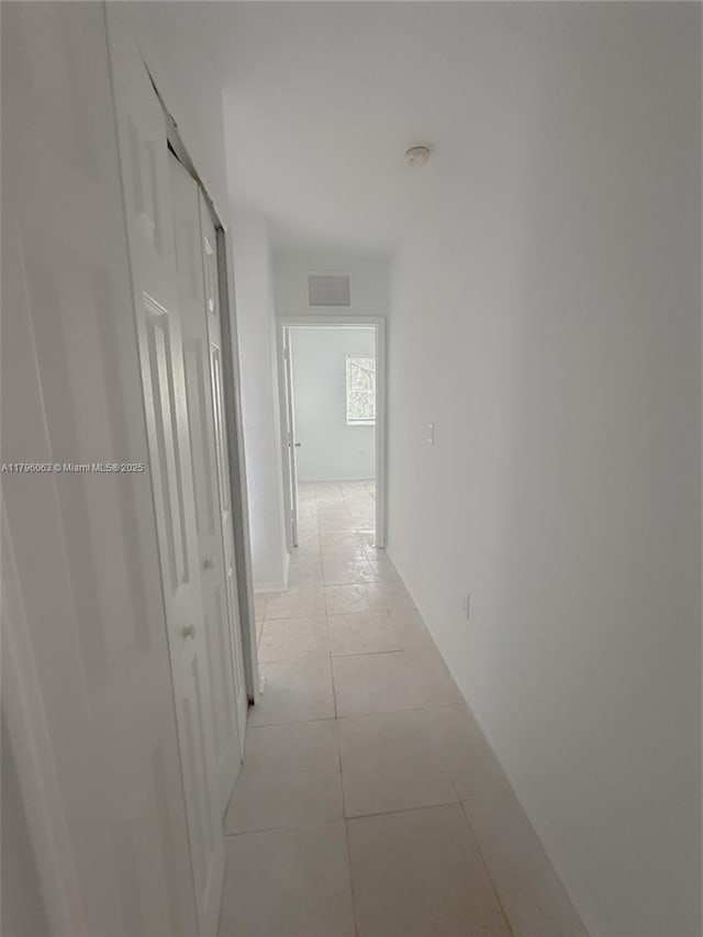 hallway with light tile patterned flooring and visible vents